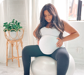 Pregnant woman on yoga ball in Toronto studio